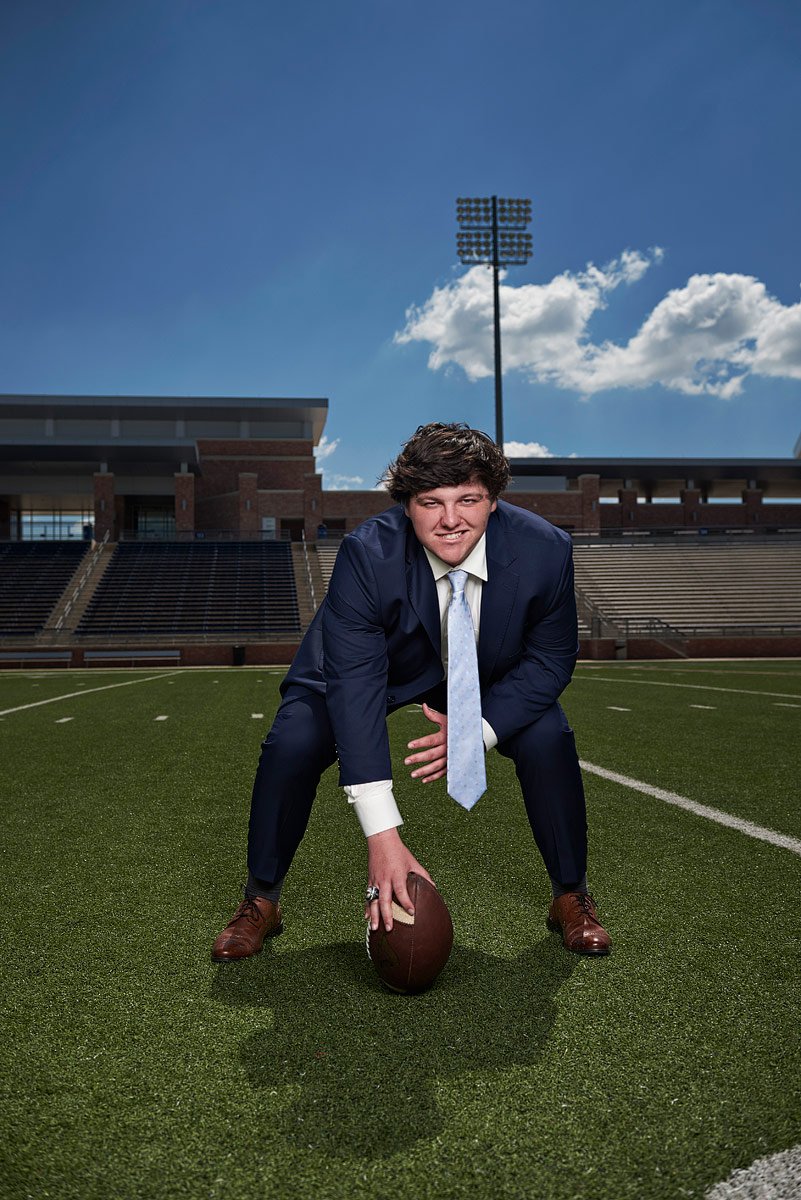 allen eagles football starting center in a blue suit gets ready to hike the ball