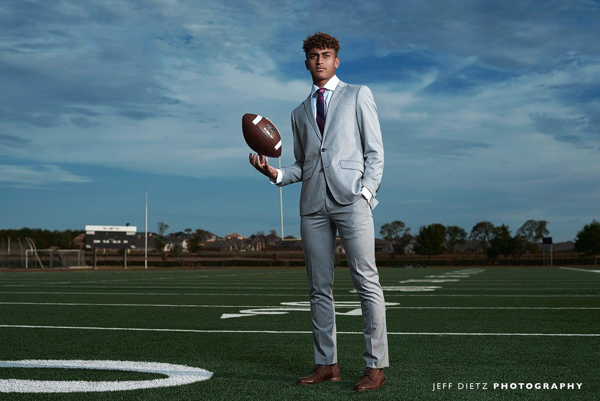 Prosper football player devin haskins in a gray suit for fashion sports photos