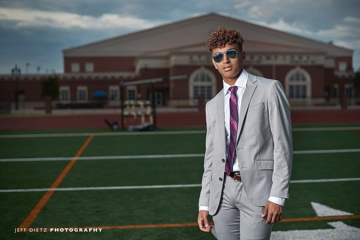 prosper senior photos with football player in sunglasses and suit