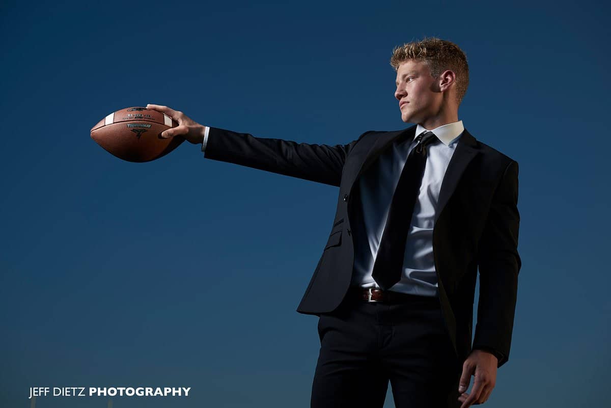 boys prosper senior portraits of football player in black suit