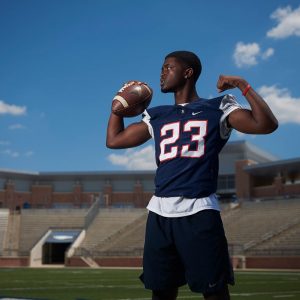 posing in allen blue jersey at the stadium for senior portraits