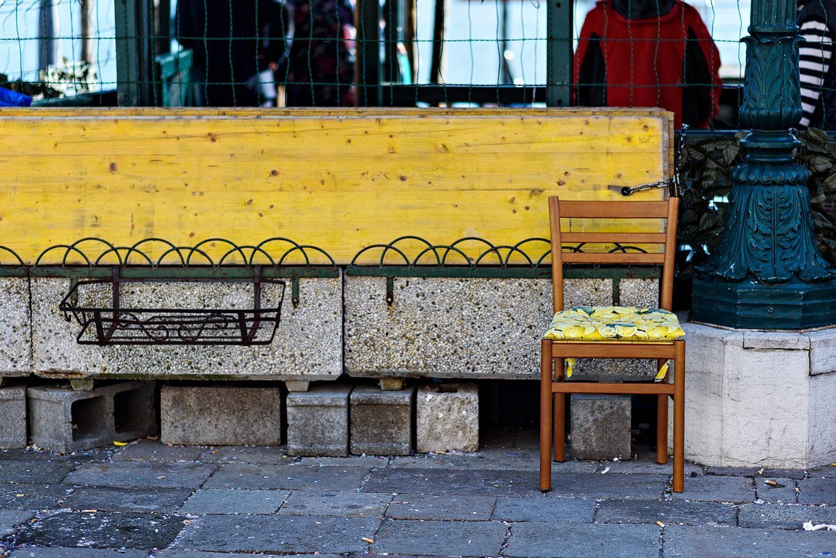 yellow wooden chair on the street in venice italy