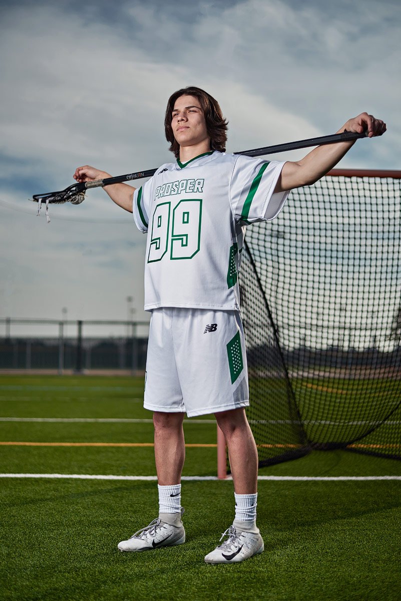 prosper lacrosse player posing for a photo with stick over shoulders at pioneer park
