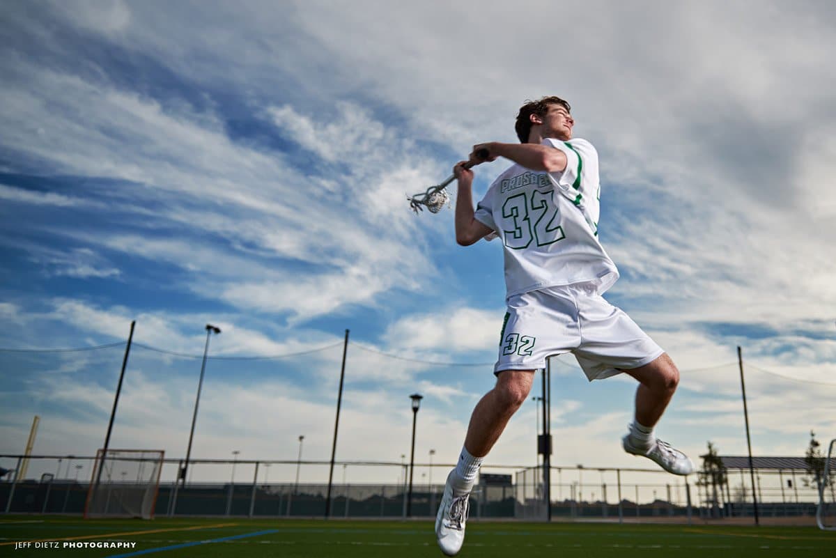 Prosper offensive lacrosse player jumping for team photo