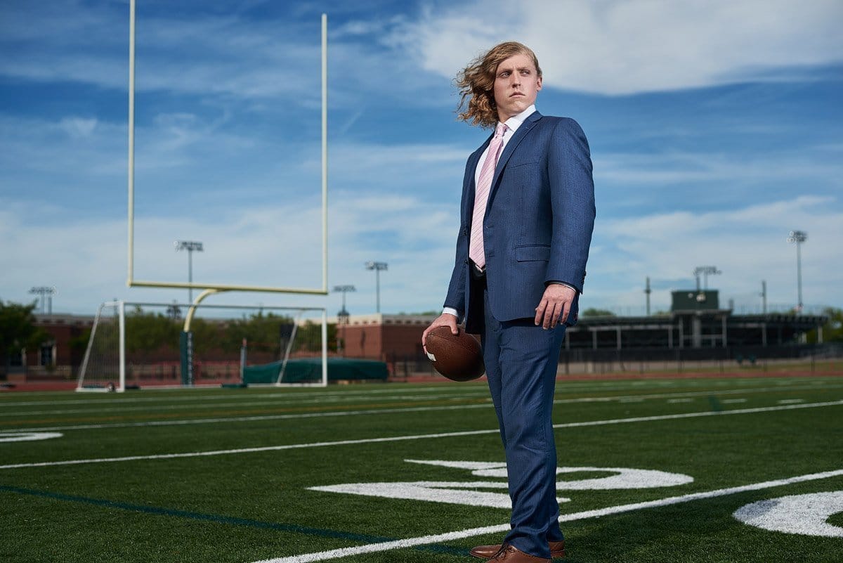 prosper senior football player in a suit on the field at the high school