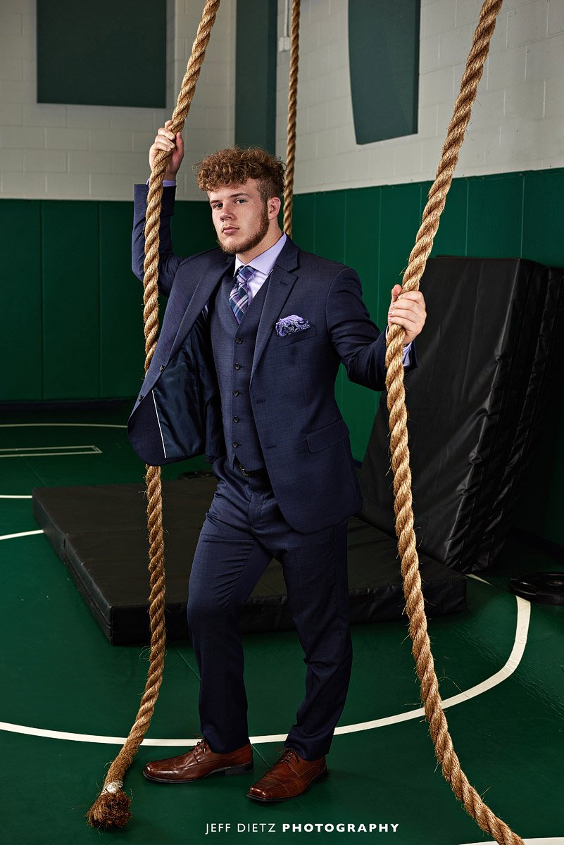 senior prosper wrestler poses with ropes for high school senior portraits