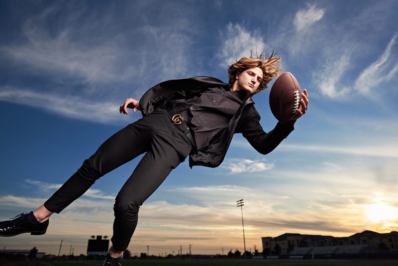Prestonwood Senior Portraits of Riley diving for football in suit christian academy plano tx