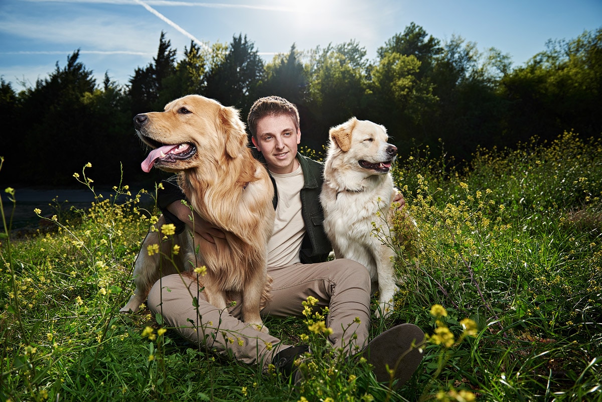 mckinney boyd senior poses with two dogs at arbor hills