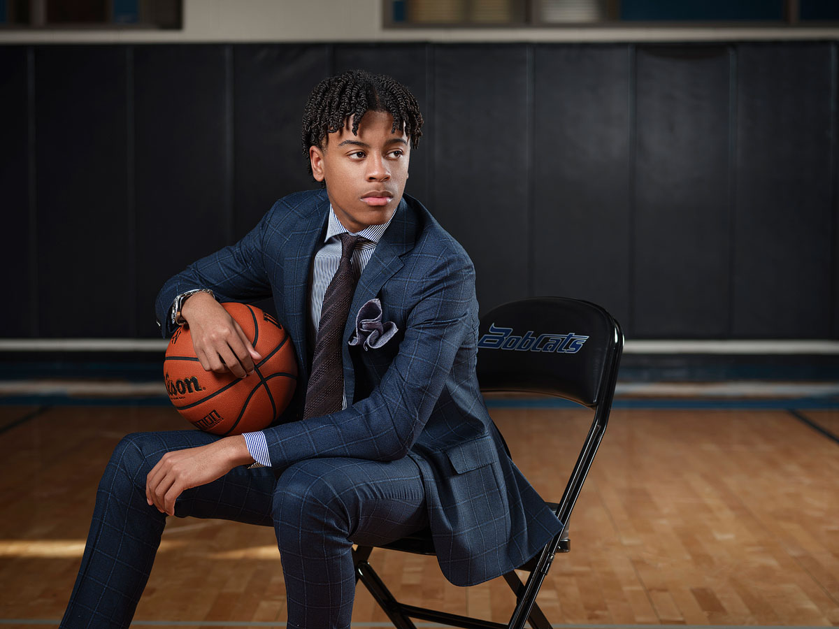 byron nelson high school senior pictures in suit in the basketball gym