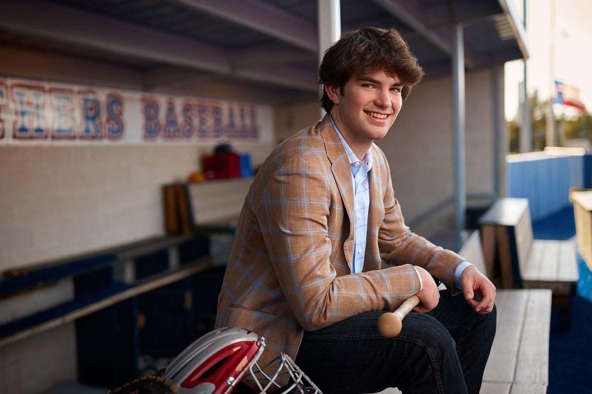 parish episcopal baseball player senior pictures in the dug out at the school by photographer jeff dietz
