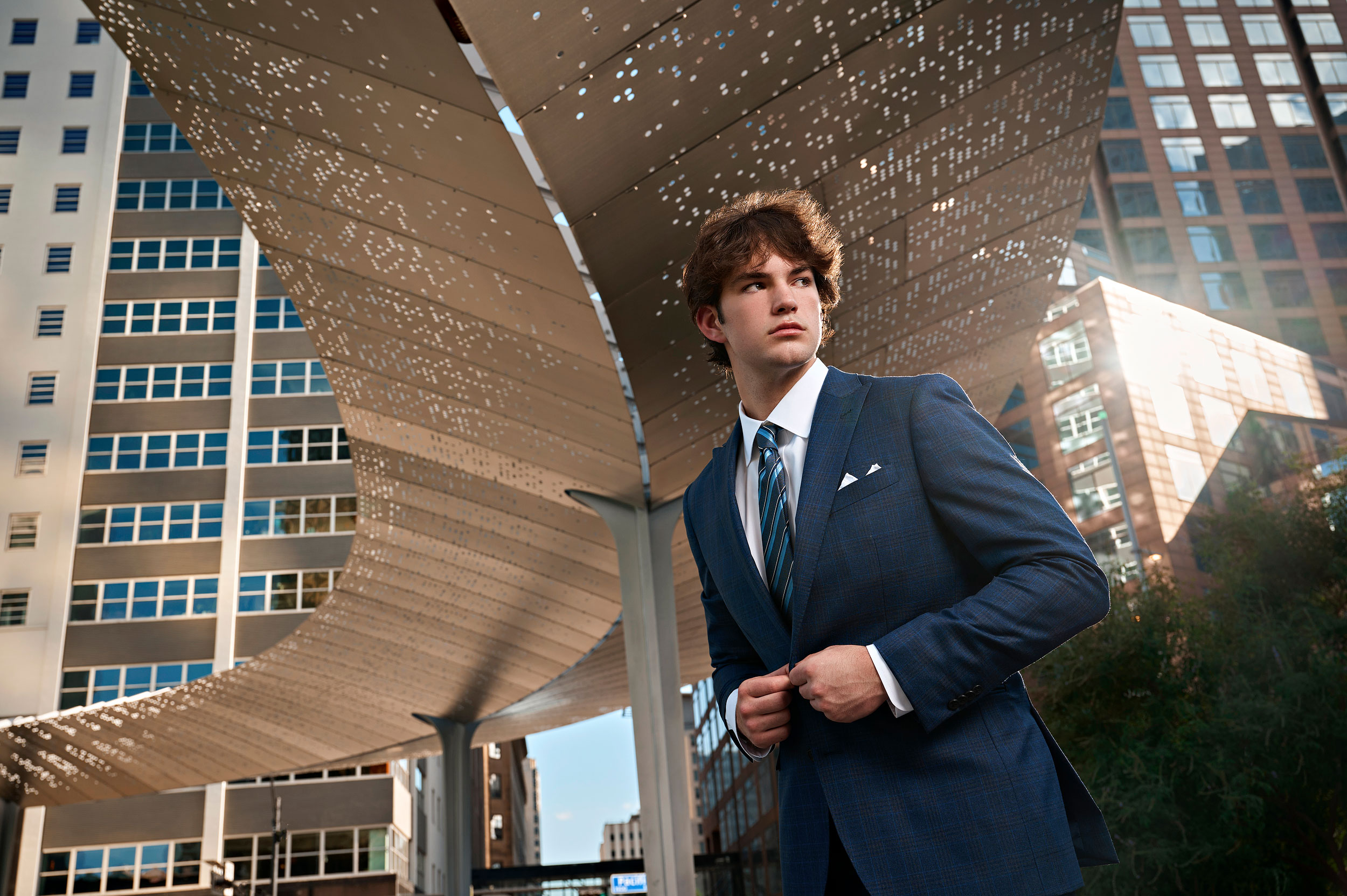 Parish episcopal senior portraits in downtown dallas of a boy in pacific plaza monument by photographer Jeff Dietz