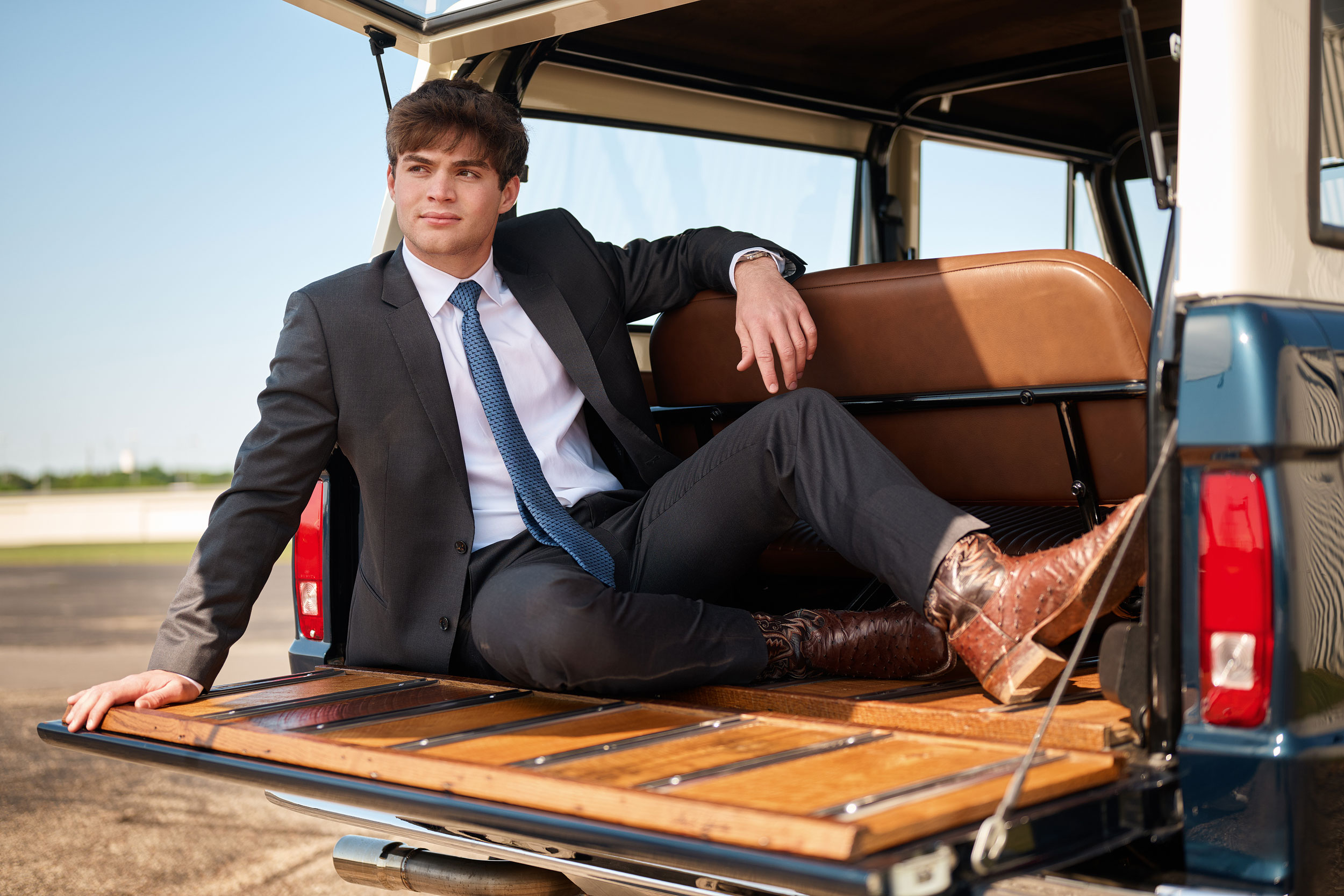 Jesuit dallas guys senior photographer sitting in back of classic jeep