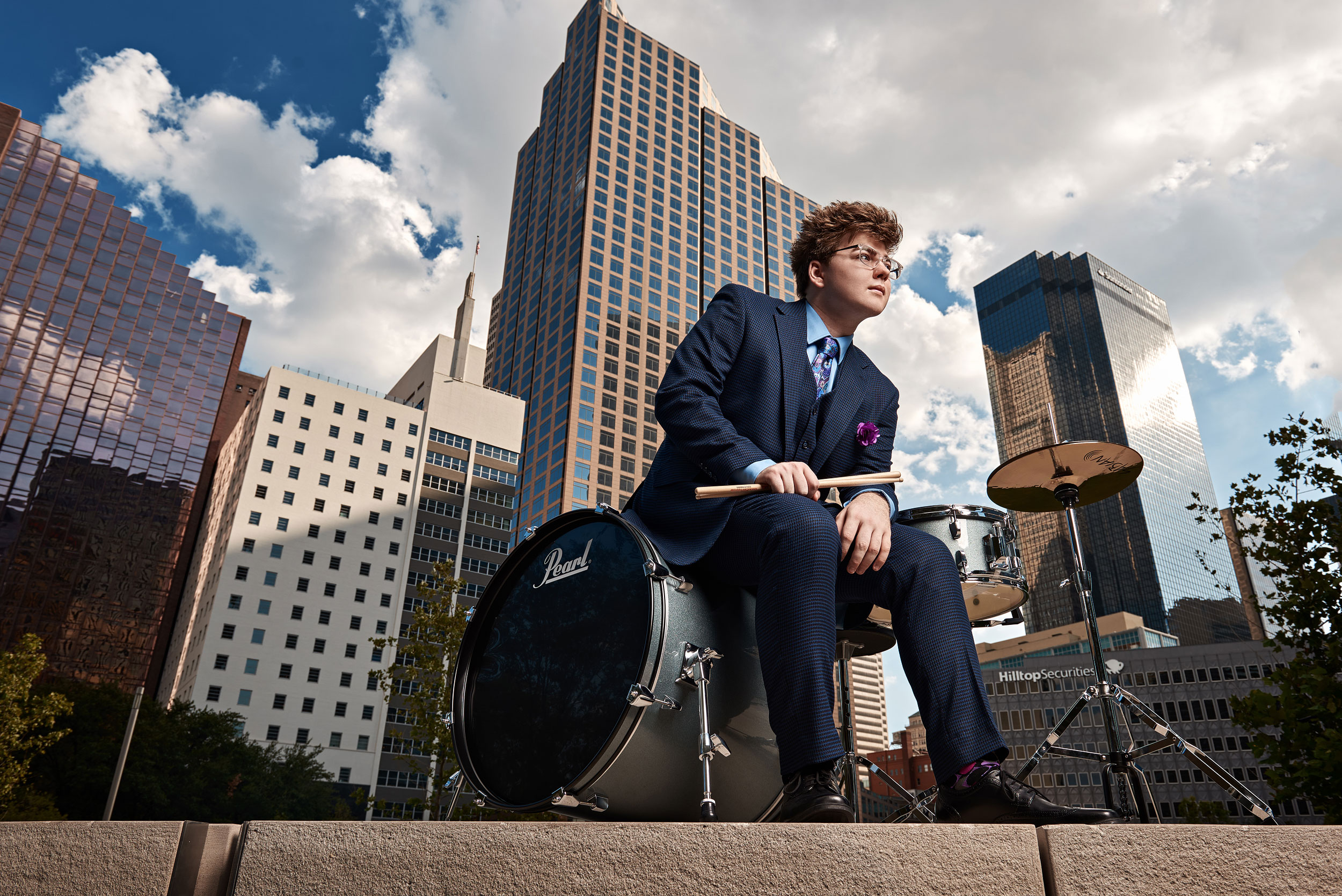 Prosper band senior portraits for guys in downtown dallas drum set in city